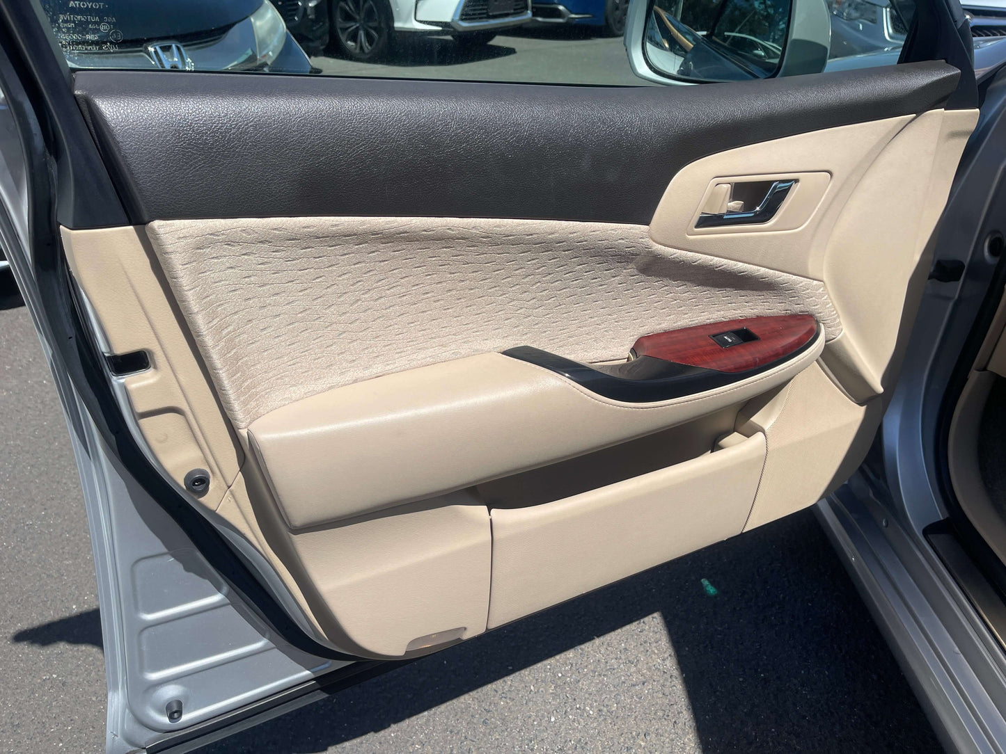 Interior door panel of a 2008 Toyota Crown V6 3.0L Royal Saloon Luxury Sedan showing fabric and wooden accents.