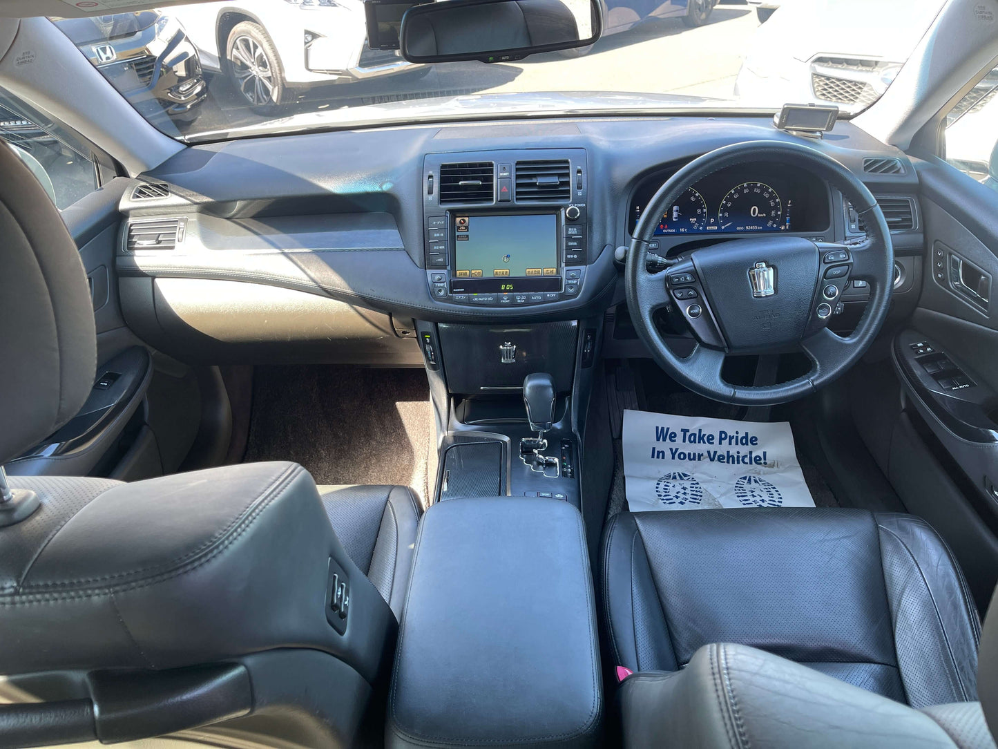 Interior view of 2009 Toyota Crown V6 3.5L Hybrid Luxury Sedan showing dashboard and seats.