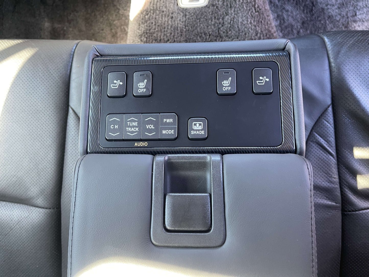 Interior control panel of a 2009 Toyota Crown V6 3.5L Hybrid luxury sedan with audio and seat adjustment buttons.
