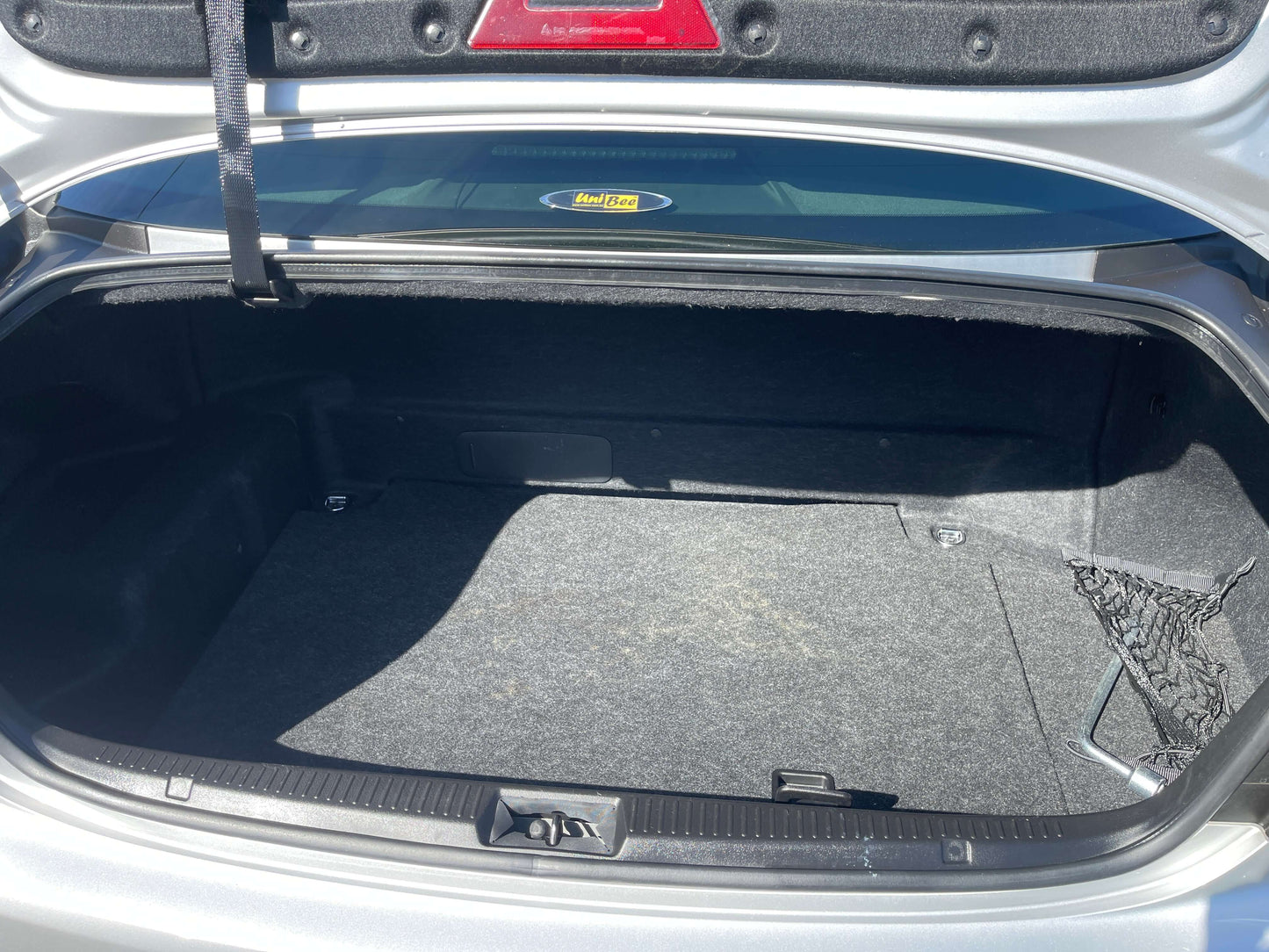 Interior view of the trunk of a 2009 Toyota Crown V6 3.5L Hybrid luxury sedan, showing ample storage space.