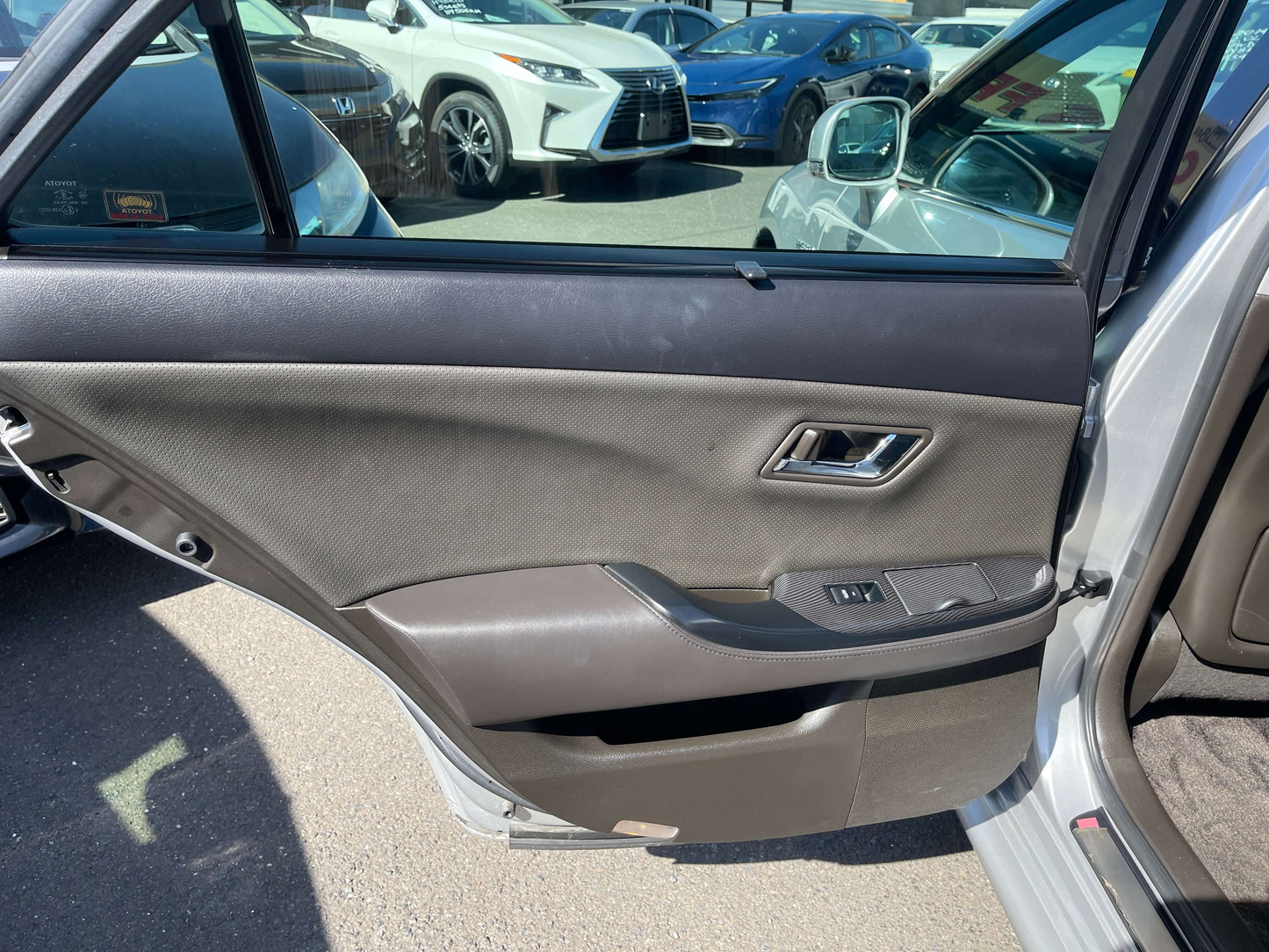 2009 Toyota Crown V6 3.5L Hybrid luxury sedan interior door panel and controls view.