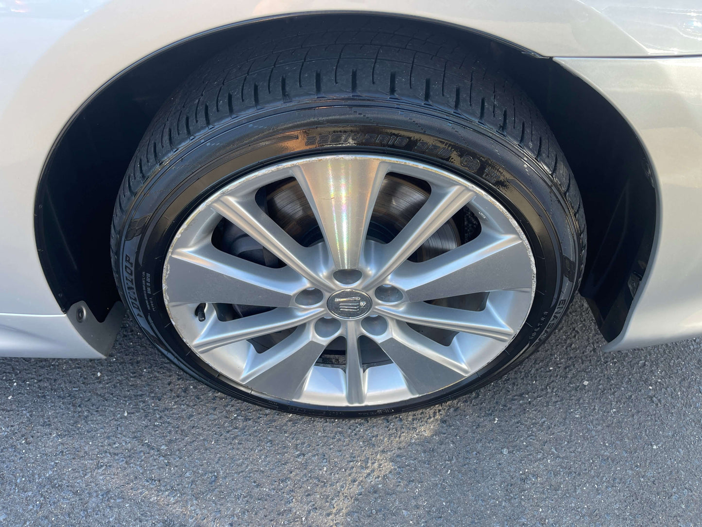 2009 Toyota Crown V6 3.5L Hybrid luxury sedan wheel with silver alloy rim and black tire.