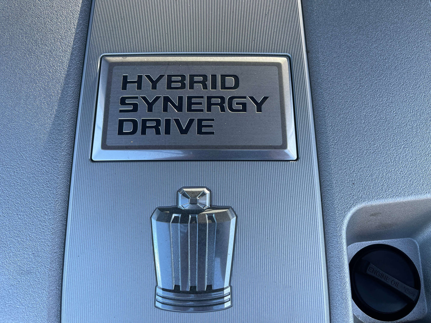 Hybrid Synergy Drive emblem from a 2009 Toyota Crown V6 3.5L Hybrid Luxury Sedan showing advanced hybrid technology.