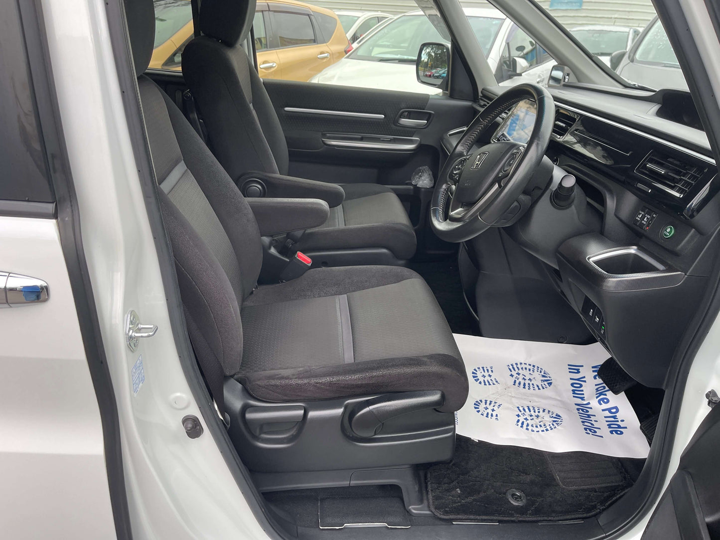 Interior view of a 2018 Honda Honda Stepwgn 2.0 Spada Hybrid with black seats and modern dashboard.