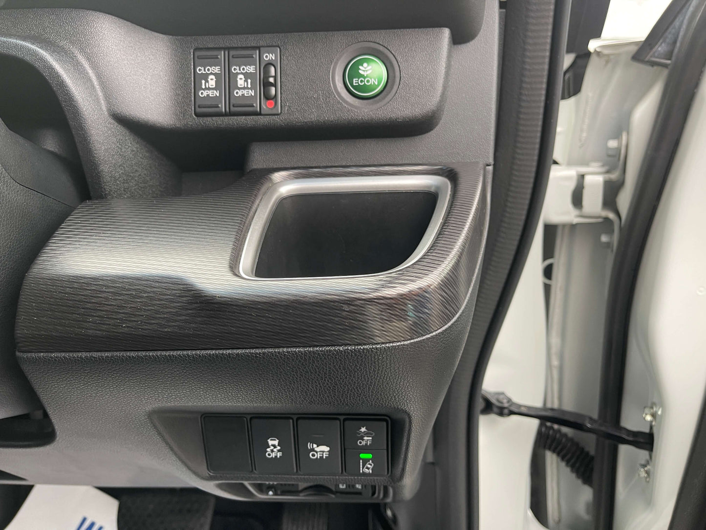 Interior controls of the 2018 Honda Honda Stepwgn 2.0 Spada Hybrid G, featuring ECO mode and window buttons.