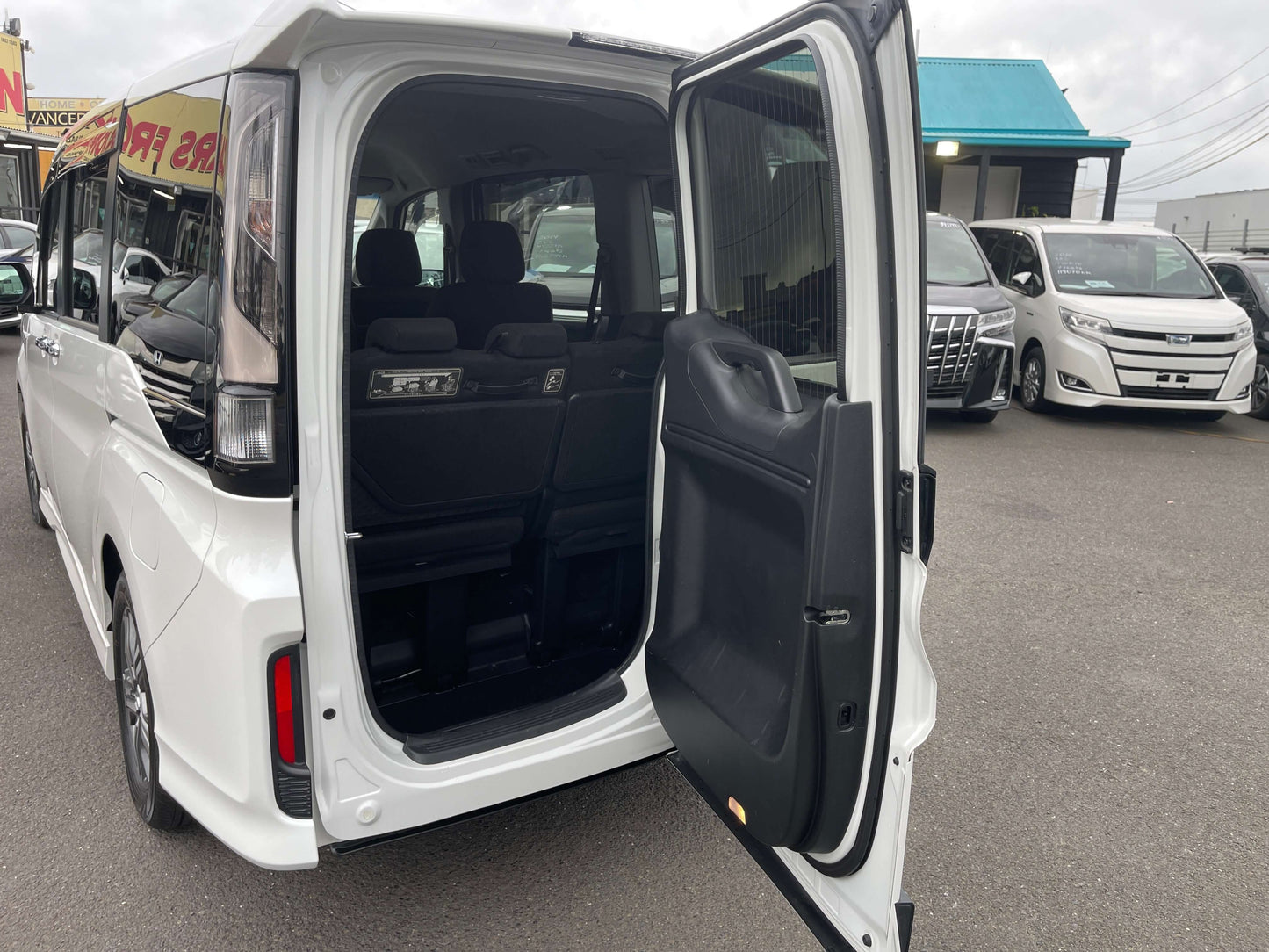 Interior view of the 2018 Honda Honda Stepwgn 2.0 Spada Hybrid showing spacious seating and open rear door.