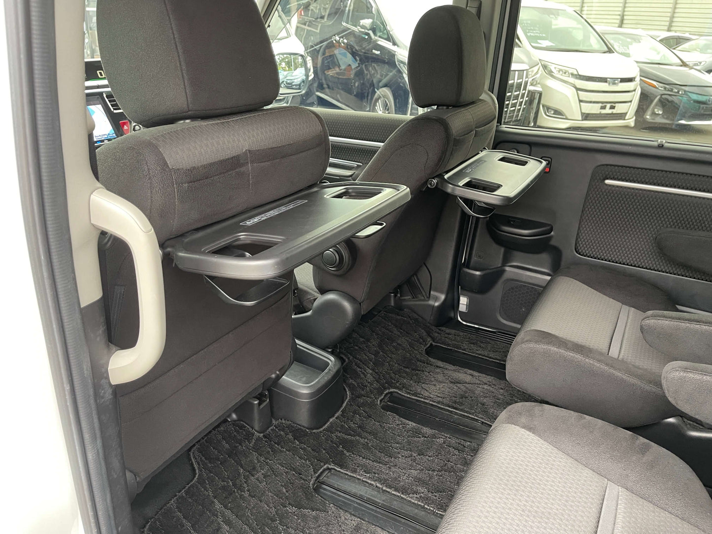 Interior seating area of 2018 Honda Honda Stepwgn 2.0 Spada Hybrid, highlighting spacious cabin and amenities.