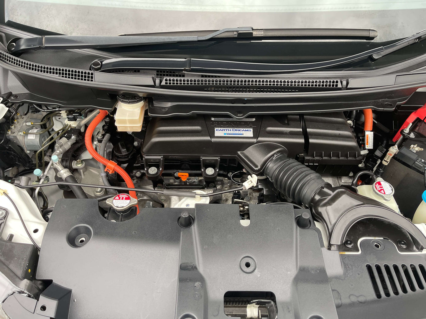 Engine compartment of the 2018 Honda Honda Stepwgn 2.0 Spada Hybrid showcasing hybrid components.