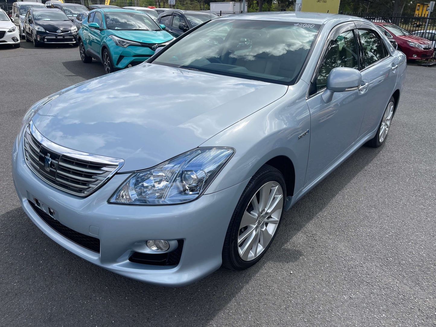 2009 Toyota Crown V6 3.5L Hybrid Luxury Sedan in blue color showcased in outdoor setting.