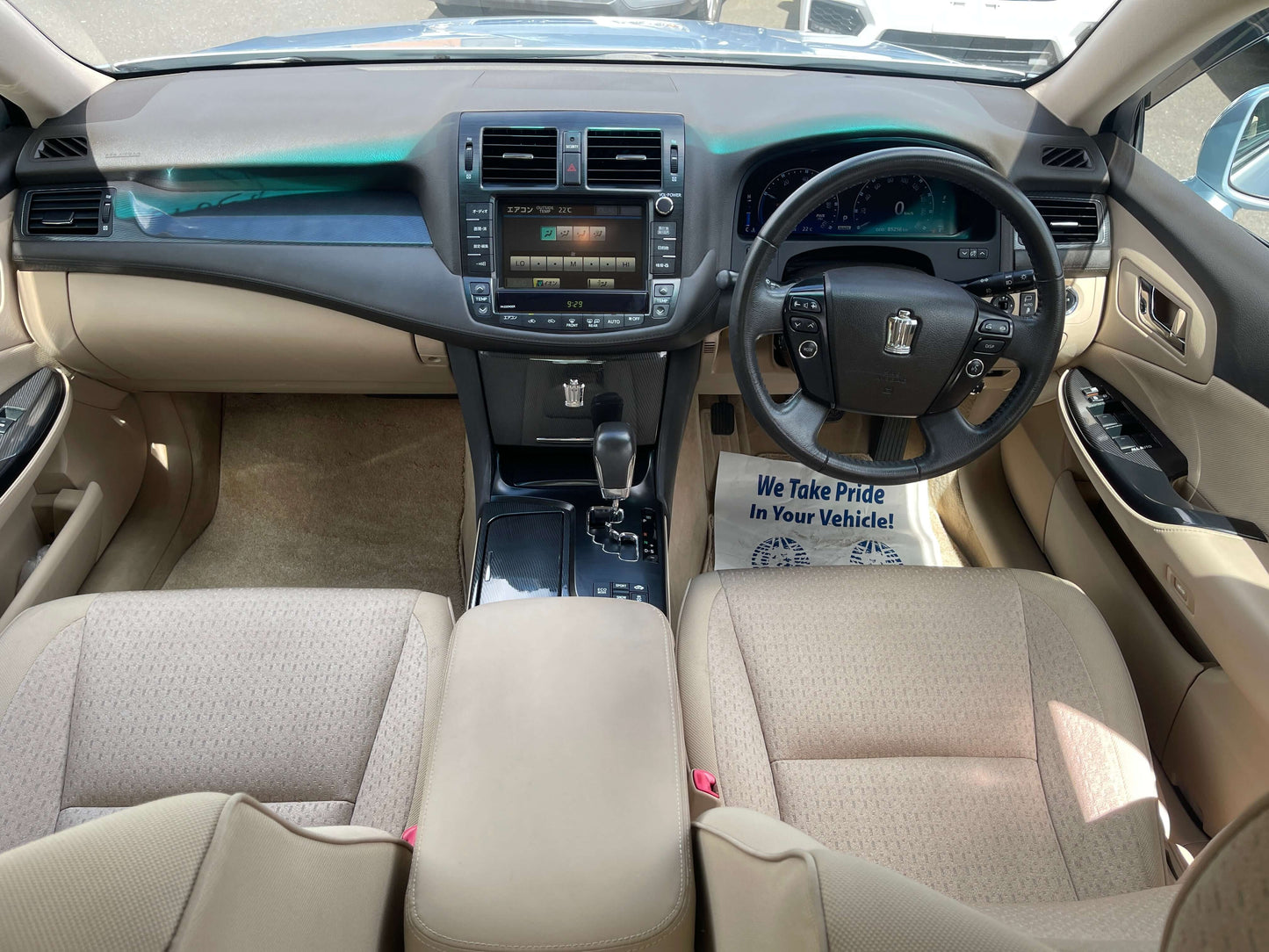 Interior view of a 2009 Toyota Crown V6 3.5L Hybrid Luxury Sedan, showcasing an elegant dashboard and seating.