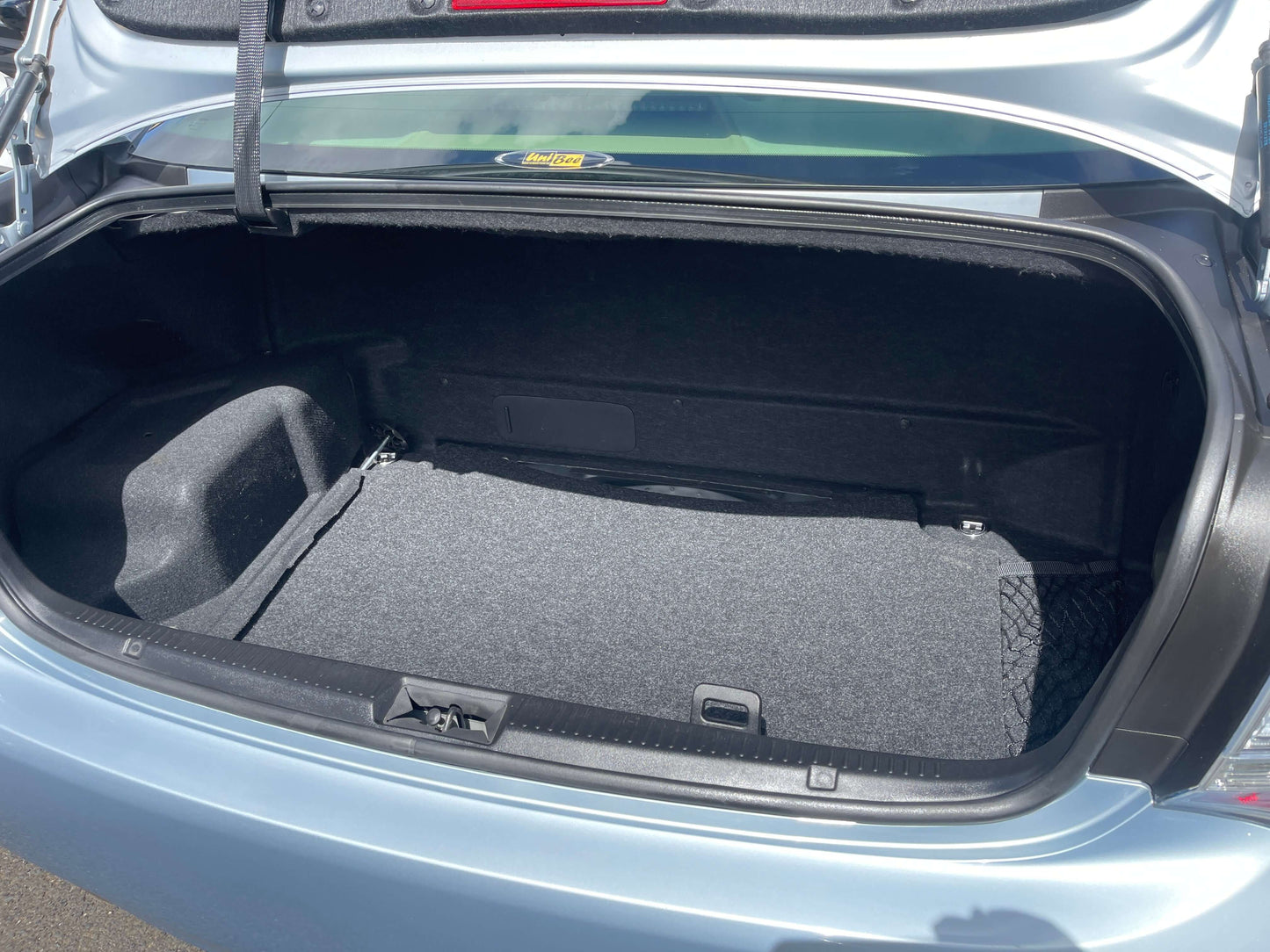 Spacious trunk interior of a 2009 Toyota Crown V6 3.5L Hybrid Luxury Sedan, showcasing ample storage space.