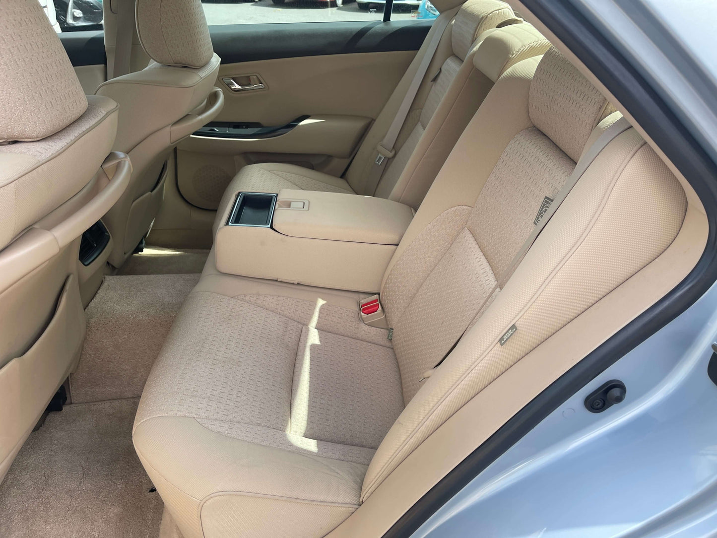 2009 Toyota Crown V6 3.5L Hybrid luxury sedan rear interior seating with beige upholstery.