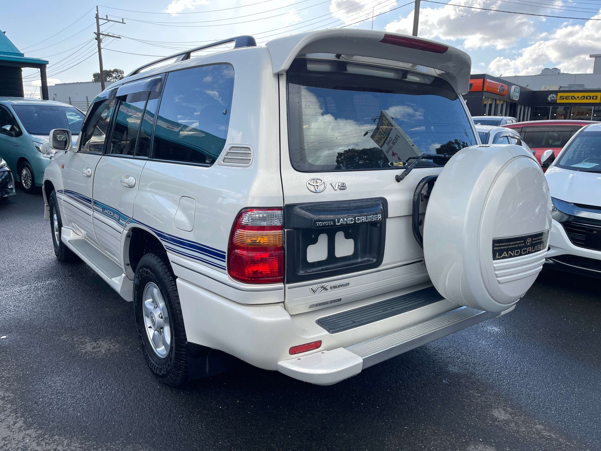1998 Toyota Land Cruiser 100 VX Limited rear view showcasing its design and spare tire.