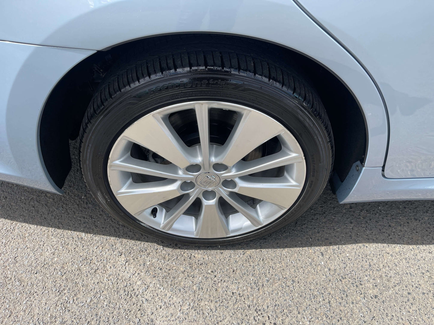 2009 Toyota Crown V6 3.5L Hybrid luxury sedan wheel close-up showing alloy rim and tire.