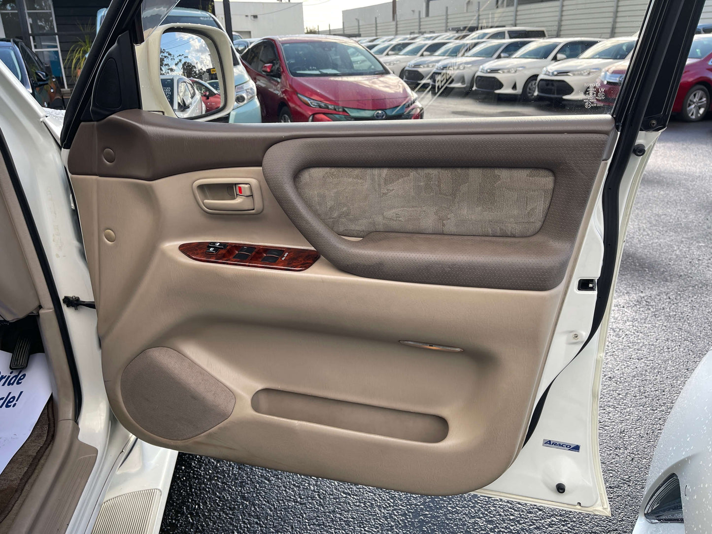 Interior door panel of a 1998 Toyota Land Cruiser 100 VX Limited showcasing premium features.