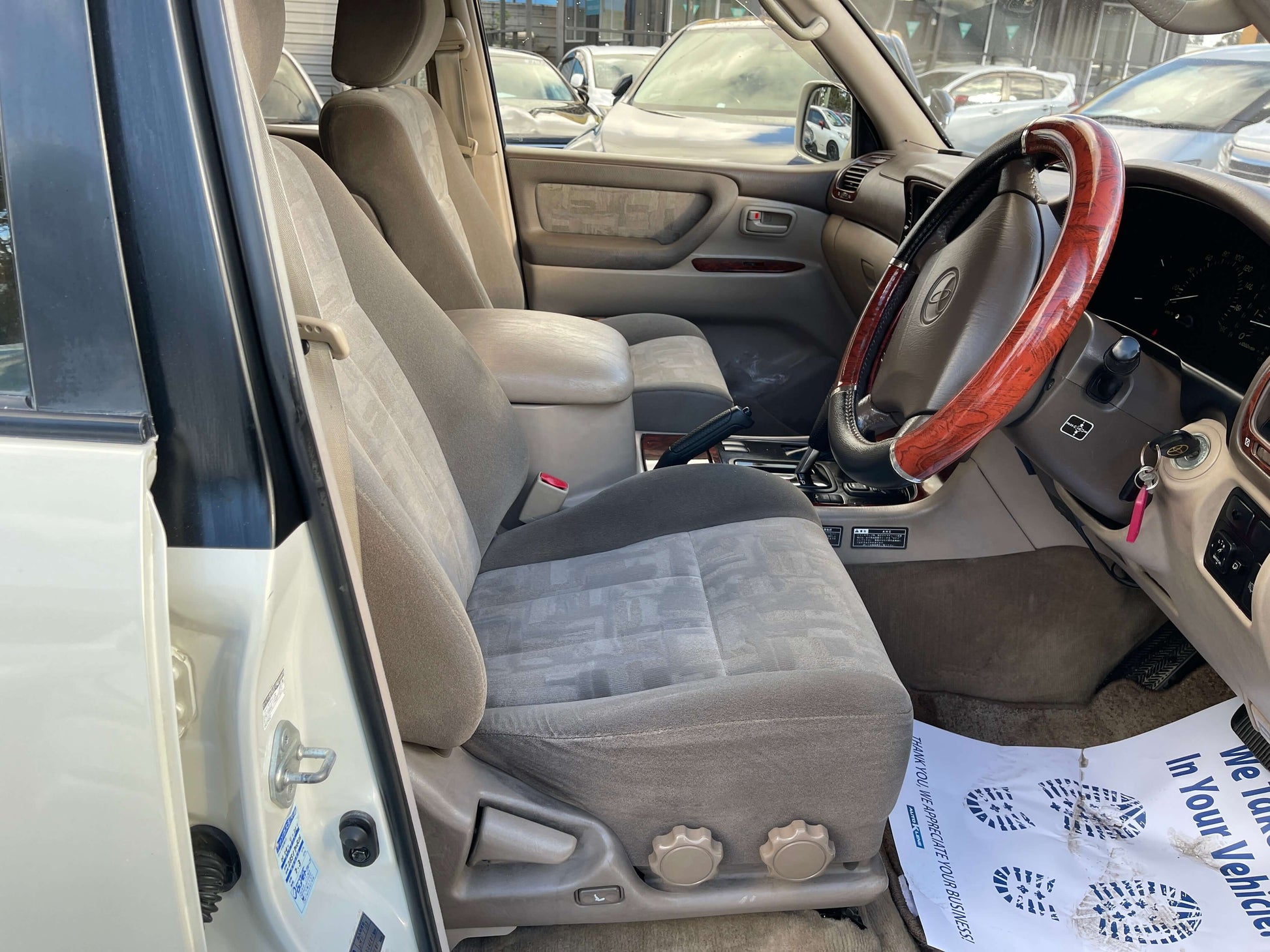 Interior view of the 1998 Toyota Land Cruiser 100 VX Limited showcasing plush seating and dashboard.