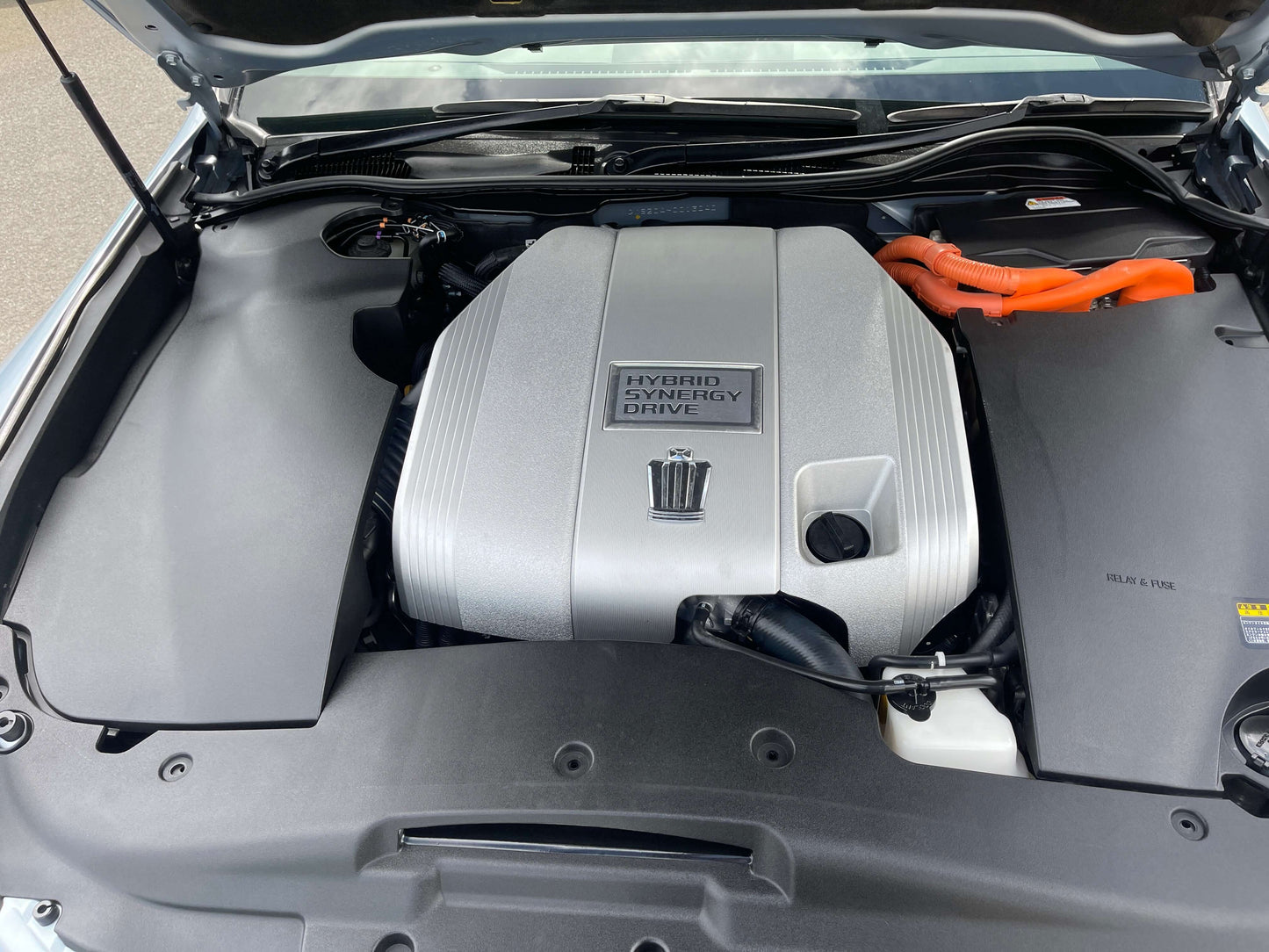 2009 Toyota Crown V6 3.5L Hybrid engine compartment featuring Hybrid Synergy Drive.