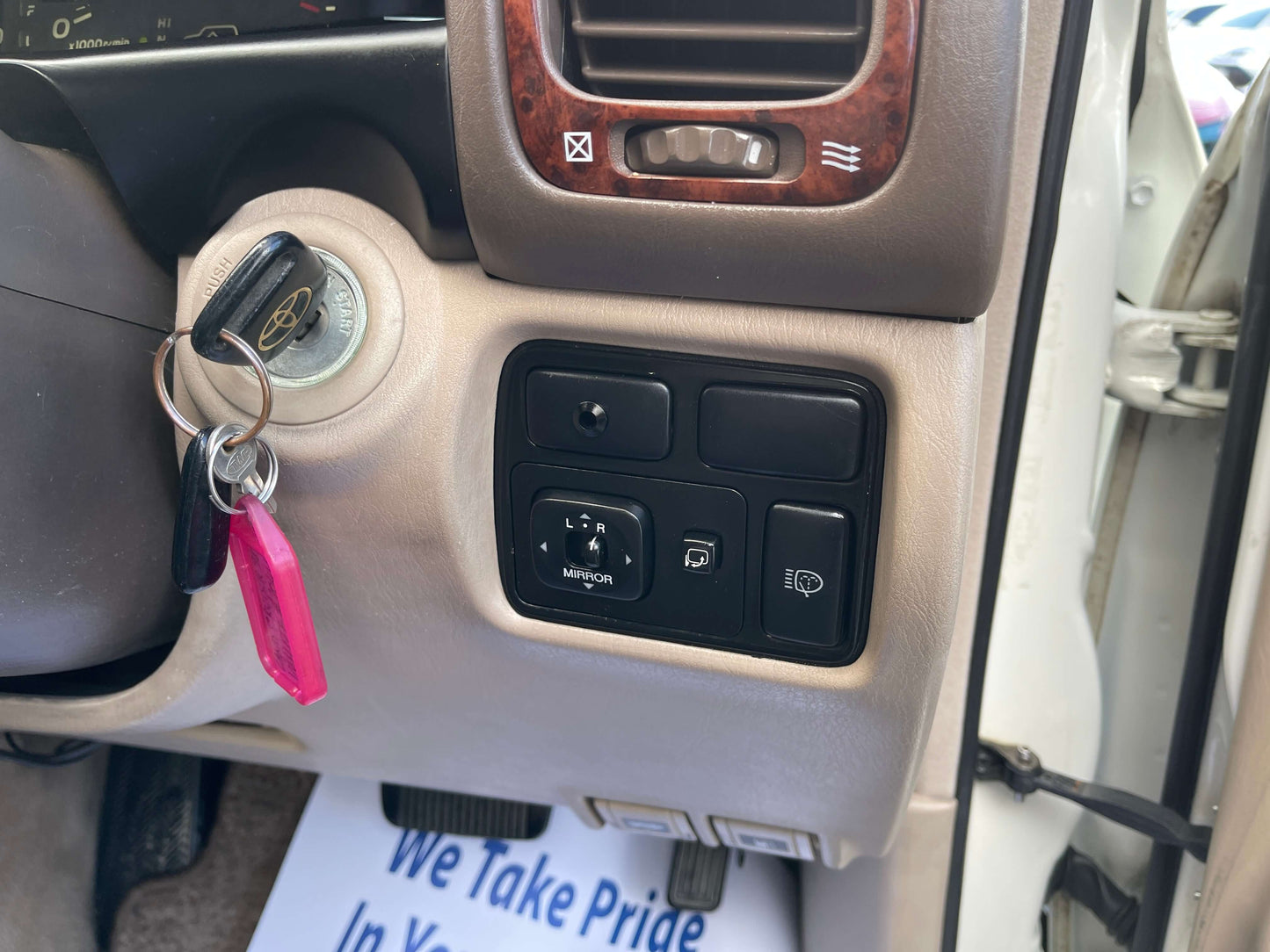 Interior view of 1998 Toyota Land Cruiser 100 VX Limited showing key ignition and control buttons.