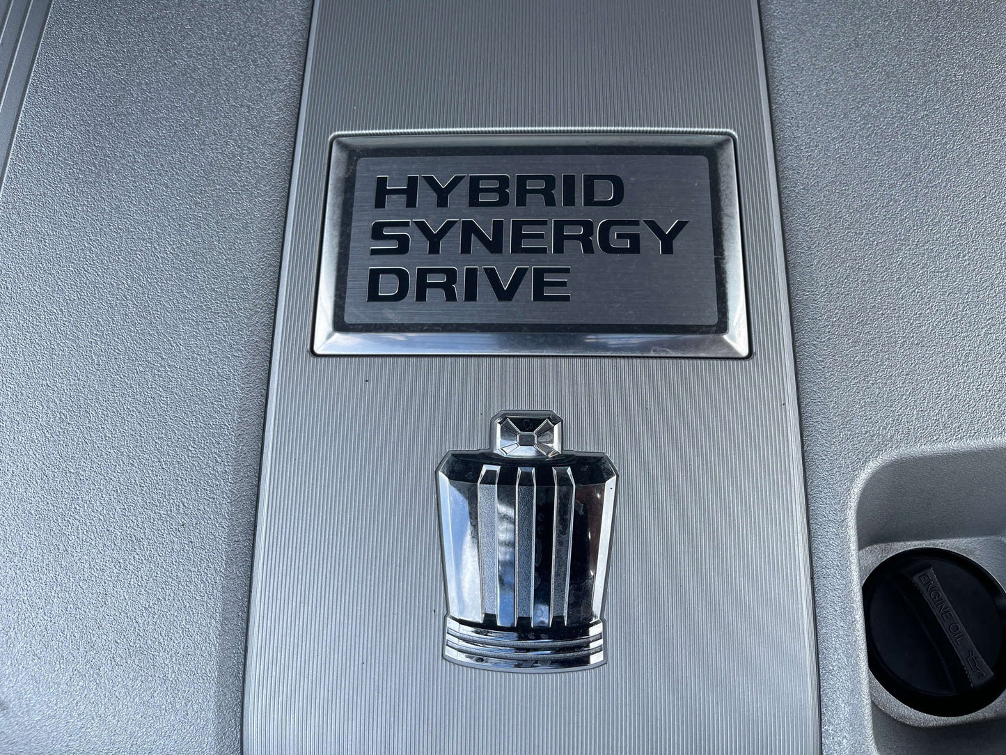 Hybrid Synergy Drive emblem on a 2009 Toyota Crown V6 3.5L Hybrid Luxury Sedan engine cover.