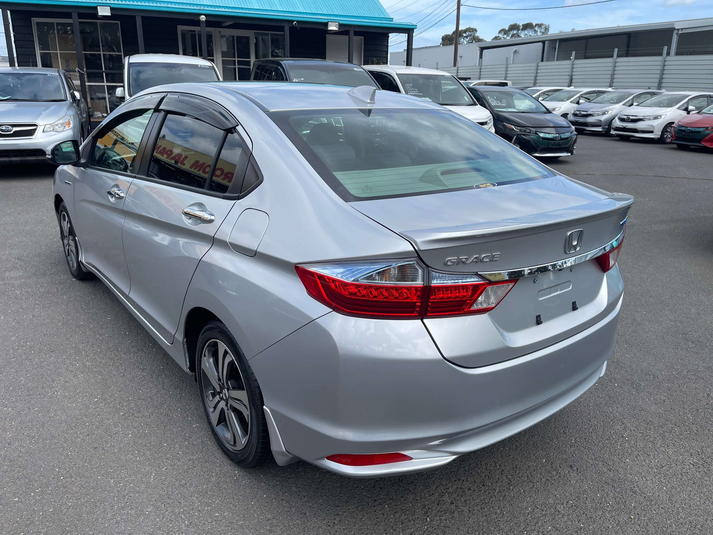 2015 Honda Grace 1.5 Hybrid EX silver sedan with a sporty rear view, showcasing sleek design and excellent engineering.