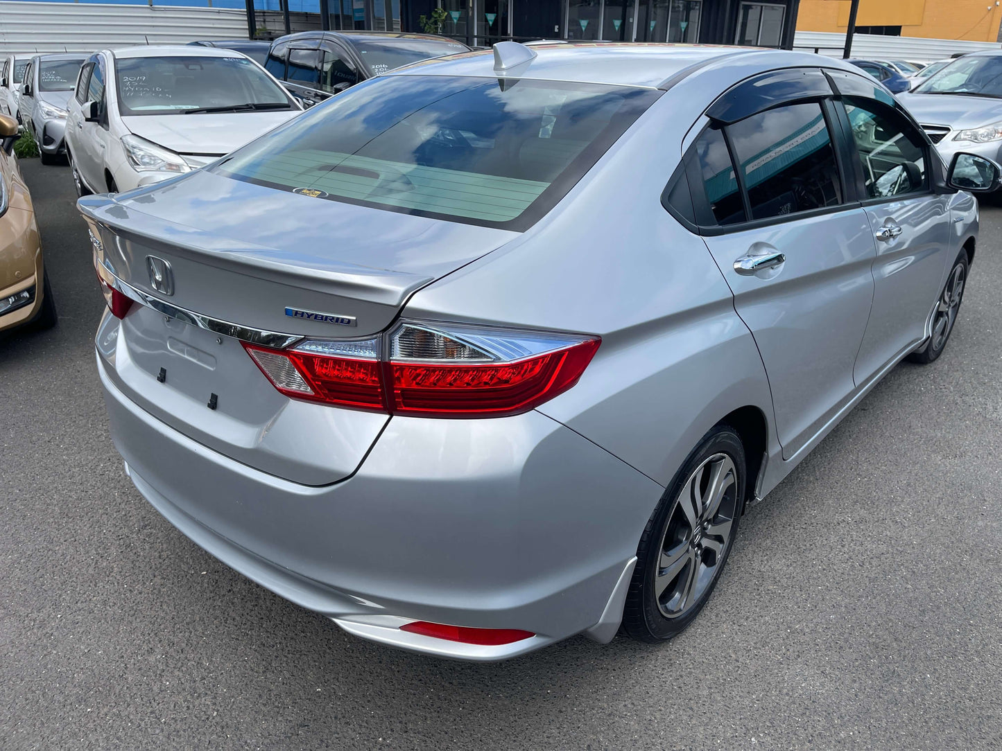 2015 Honda Grace 1.5 Hybrid EX 5 seater sedan rear view showcasing sleek silver design and modern styling.