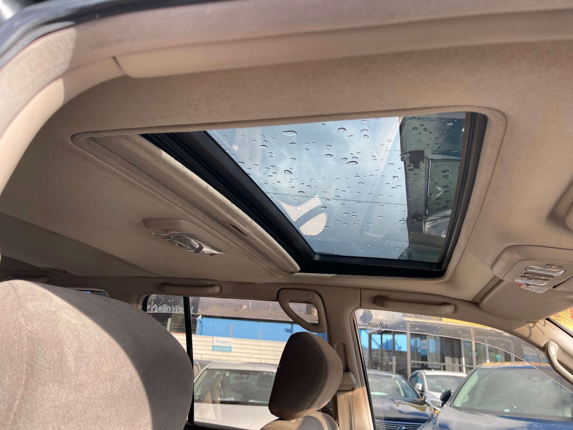 Interior view of 1998 Toyota Land Cruiser 100 VX Limited showing sunroof and vehicle features.