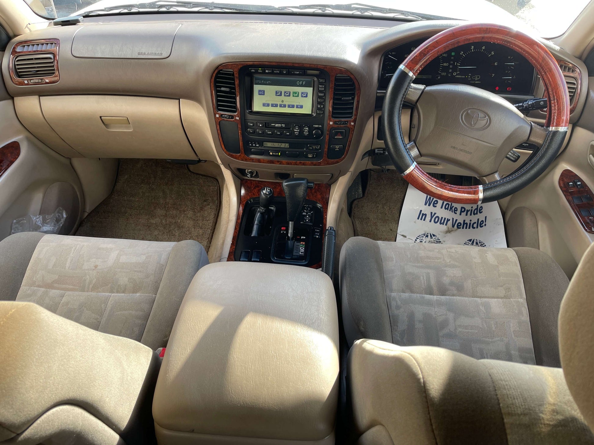 Interior view of the 1998 Toyota Land Cruiser 100 VX Limited, showing dashboard, seats, and controls.