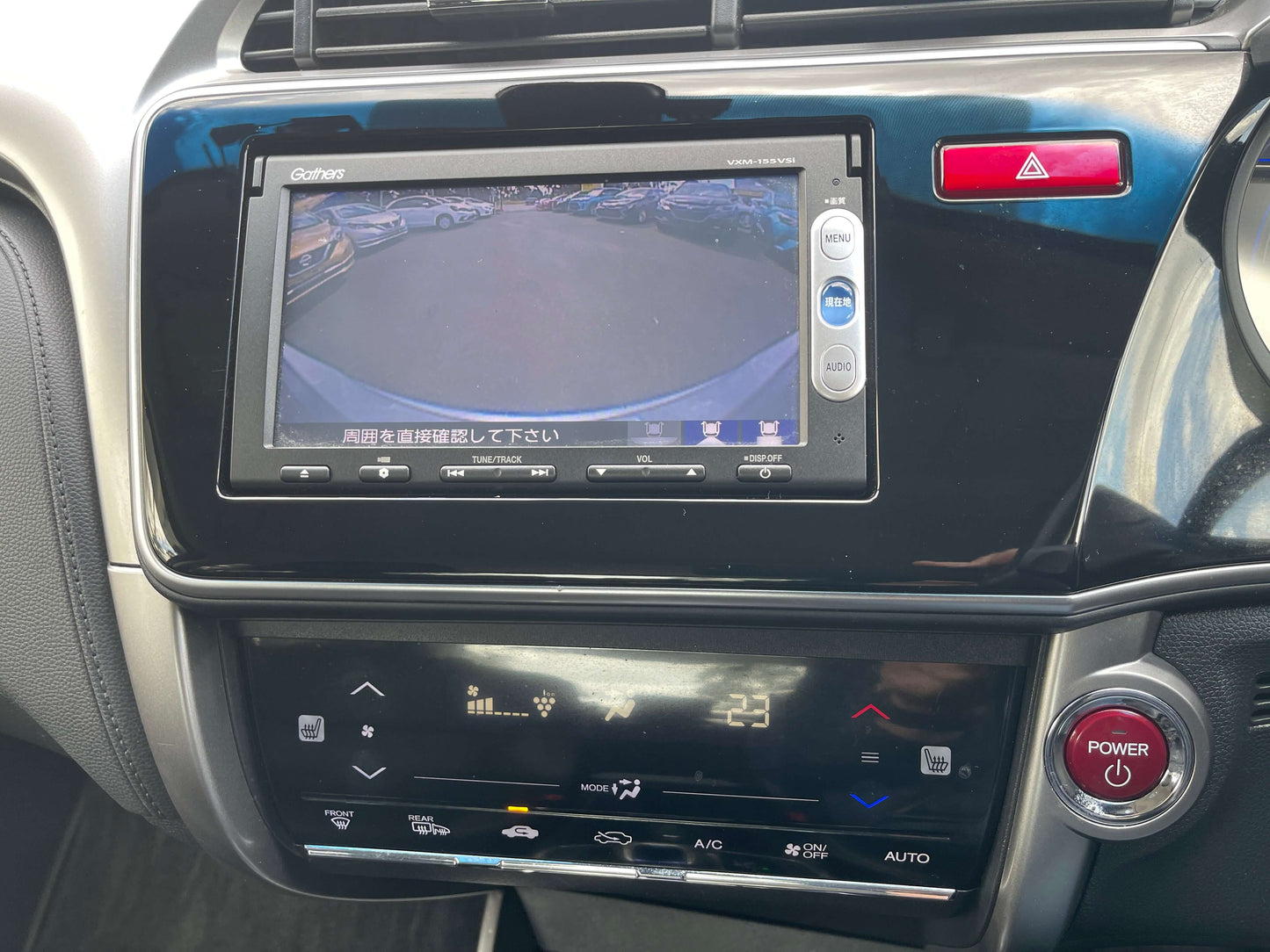 Interior dashboard of a 2015 Honda Grace 1.5 Hybrid showing infotainment screen and climate control settings.