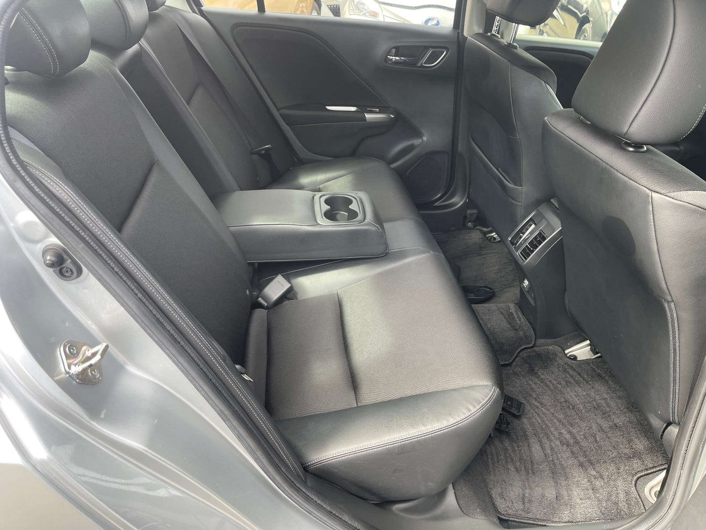 Interior view of the back seat of a 2015 Honda Grace 1.5 Hybrid EX with comfortable seating for five.