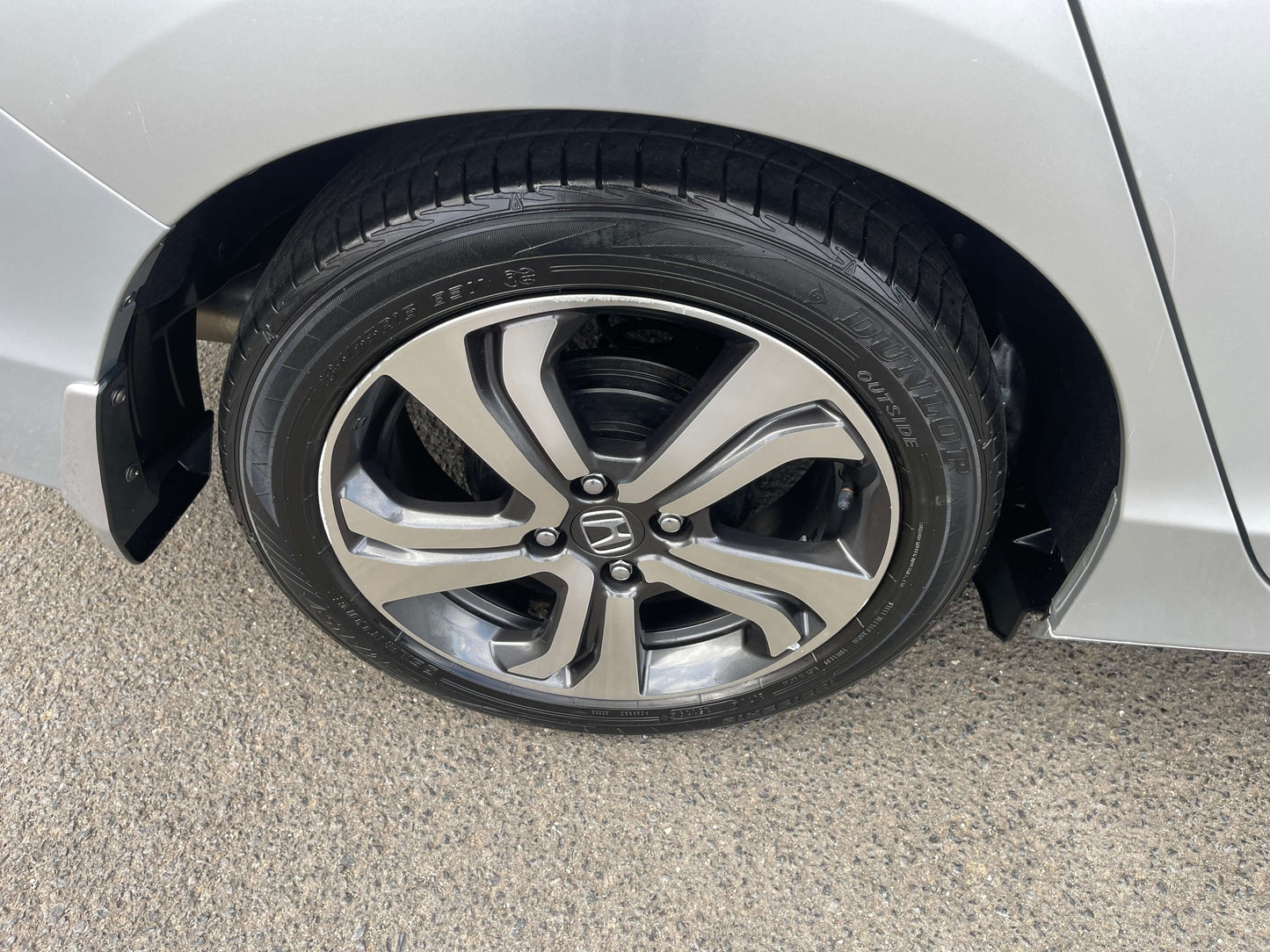 Close-up of the alloy wheel on a 2015 Honda Grace 1.5 Hybrid EX 5 seater sedan.