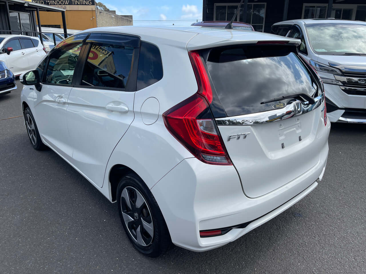 2017 Honda Fit 1.5L Hybrid rear view, showcasing sleek design and modern features in a white color.