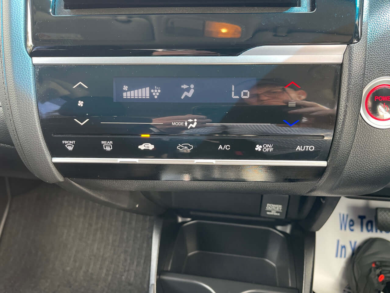 Dashboard control panel of a 2017 Honda Fit 1.5L Hybrid showcasing climate control features.