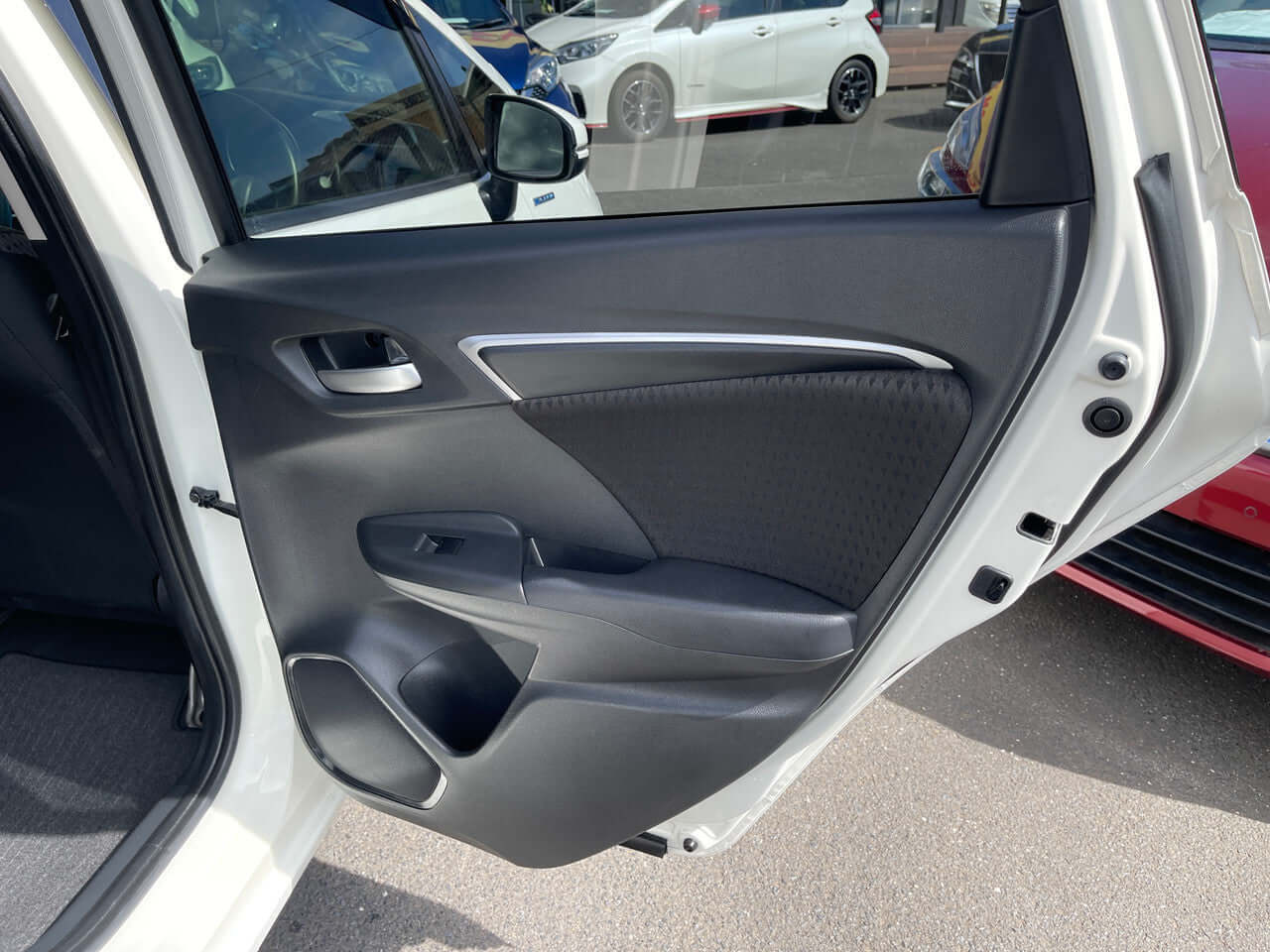 Interior view of the 2017 Honda Fit 1.5L Hybrid door showcasing the modern design and ergonomic features.