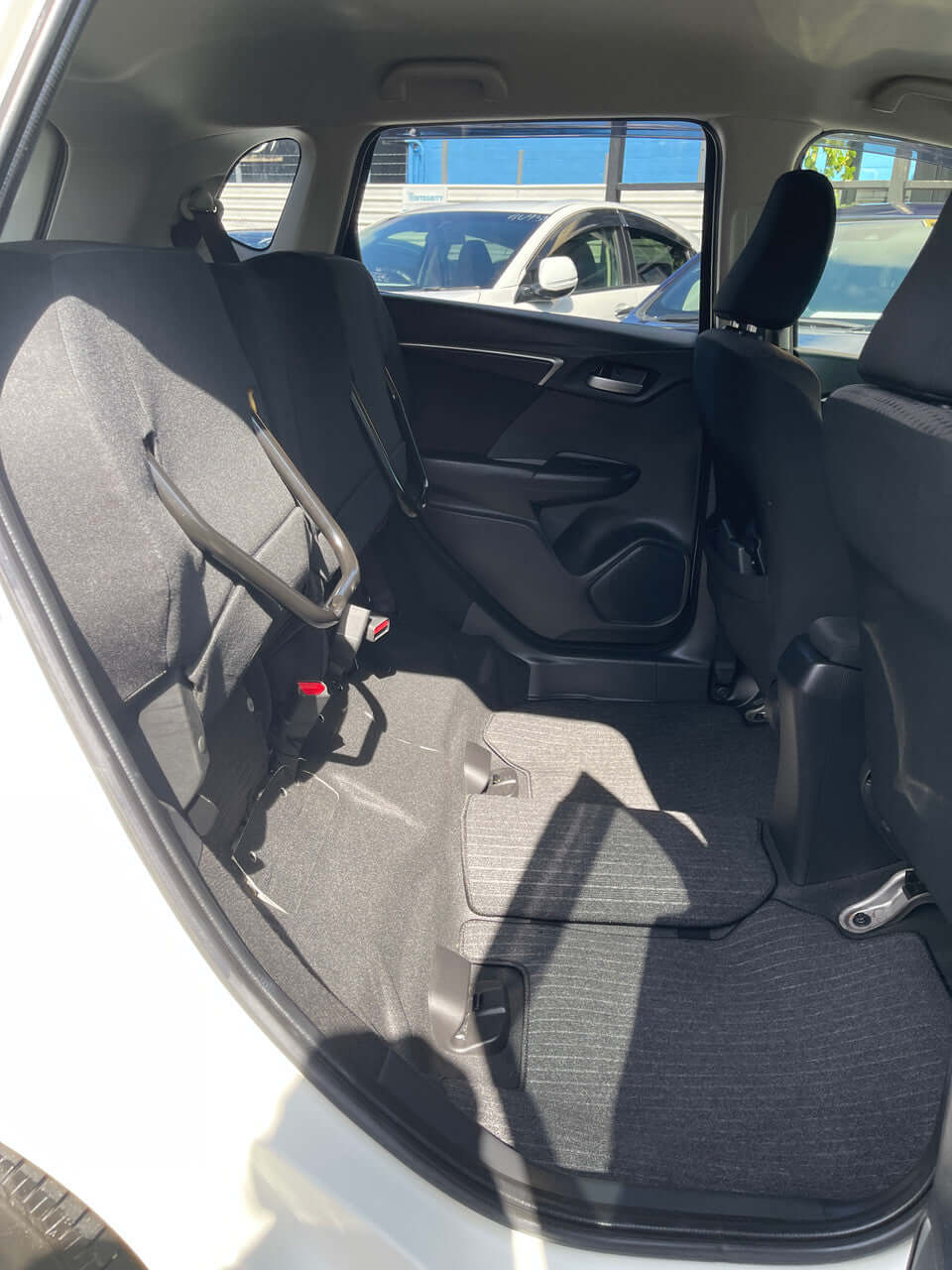 Interior view of the back seats of a 2017 Honda Fit 1.5L Hybrid, showcasing spacious seating for 5.