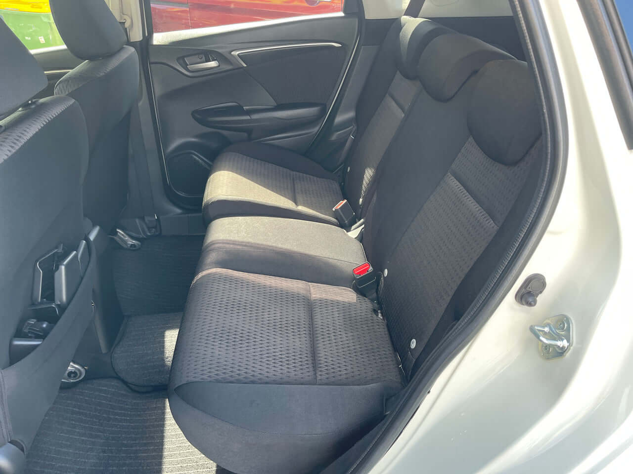Interior view of the 2017 Honda Fit 1.5L Hybrid featuring spacious back seats for comfortable seating.