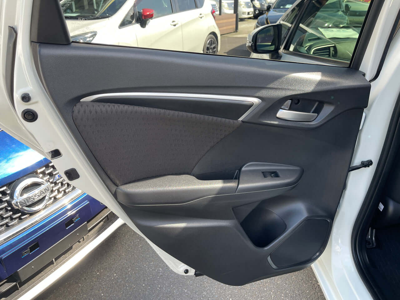 Interior view of the 2017 Honda Fit 1.5L Hybrid door panel showcasing modern design and finishes.