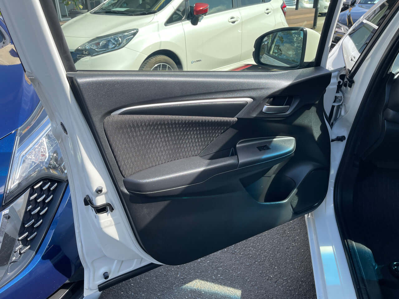 Interior view of 2017 Honda Fit 1.5L Hybrid door panel showcasing modern design and features.