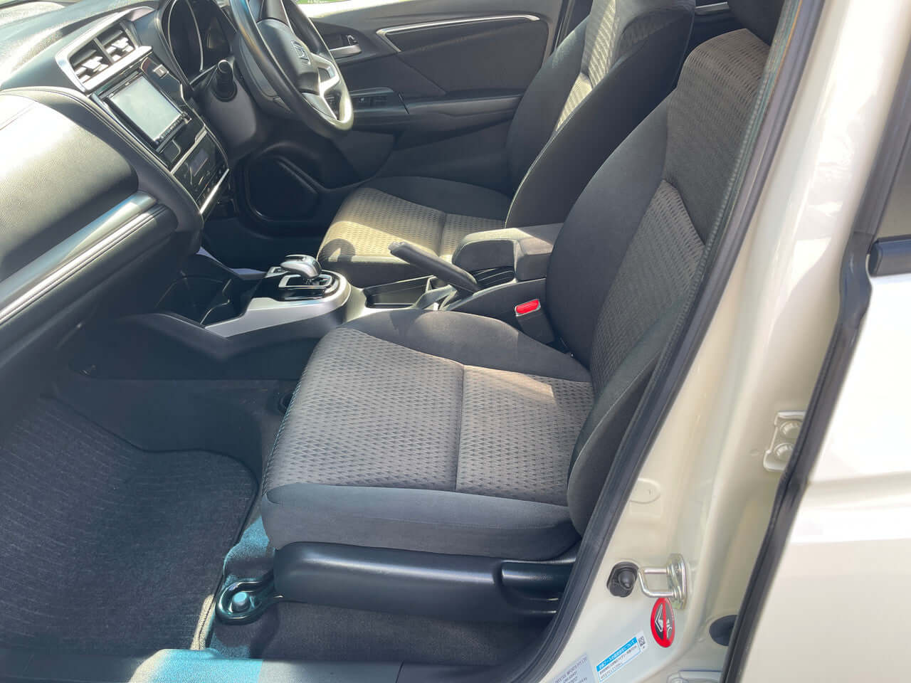 Interior view of 2017 Honda Fit 1.5L Hybrid showing comfortable seating and dashboard features.