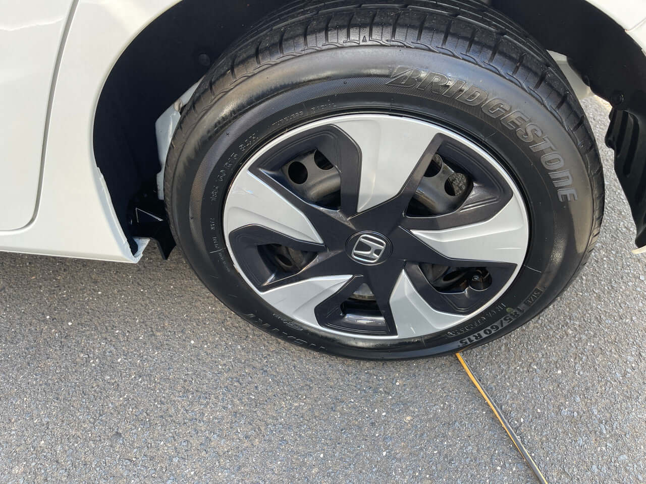 2017 Honda Fit 1.5L Hybrid wheel close-up showing stylish alloy design and Bridgestone tire.