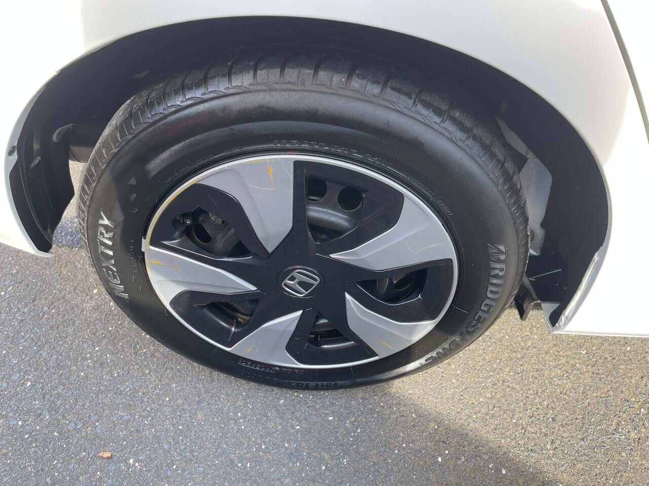 2017 Honda Fit 1.5L Hybrid wheel and tire close-up with stylish black and silver rim.