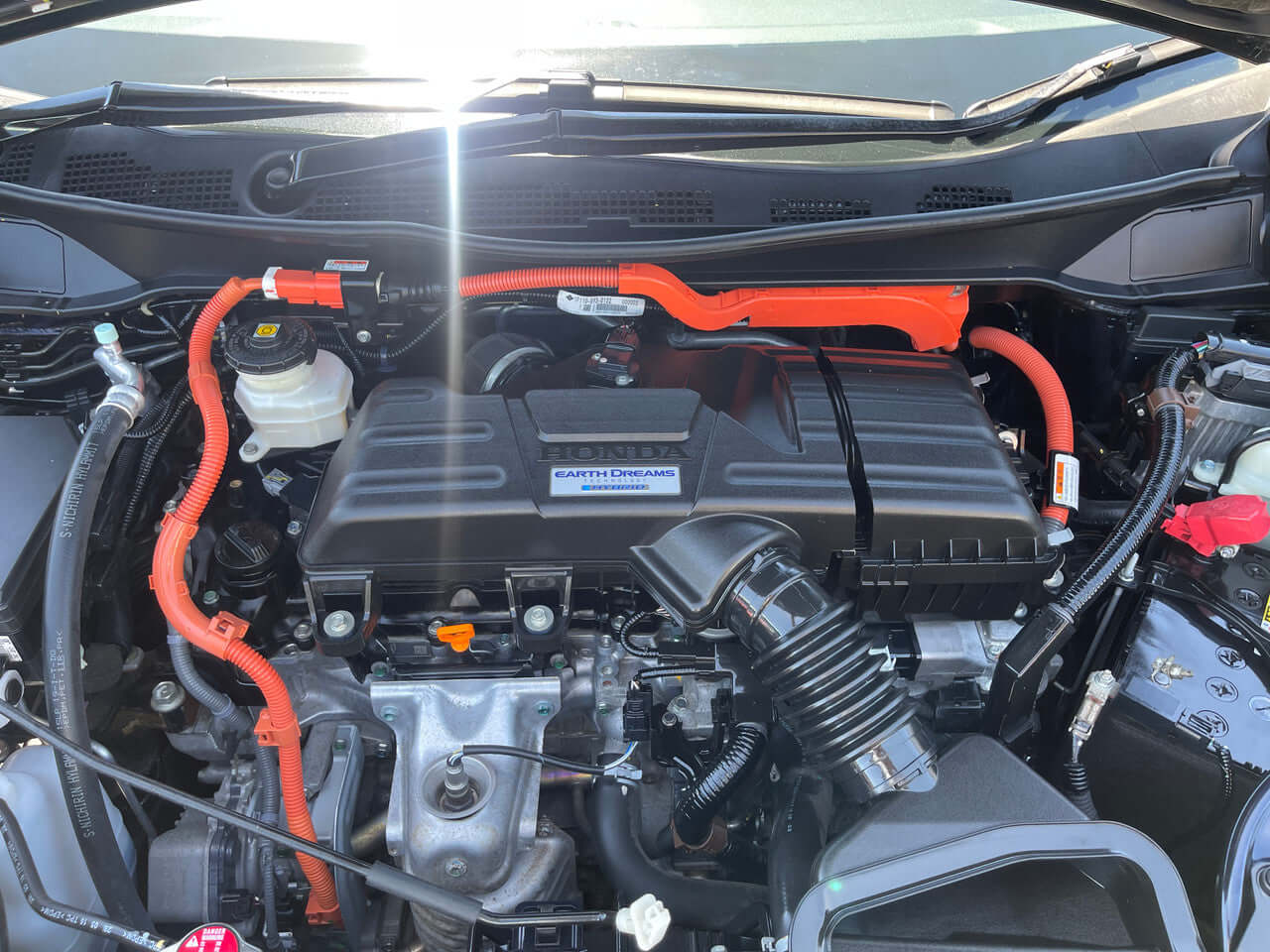 2016 Honda Odyssey 2.0 Hybrid engine compartment showcasing advanced hybrid technology and components.