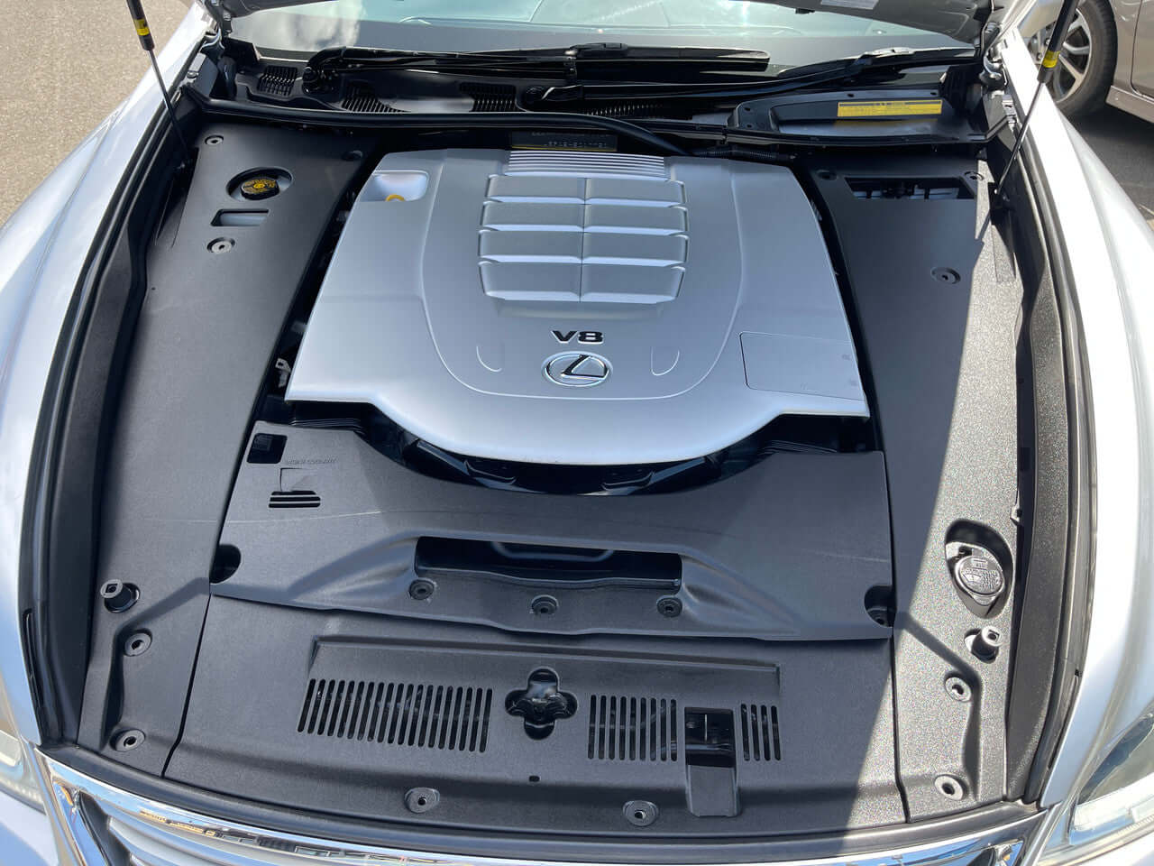 Engine bay of 2013 Lexus LS460 AWD V8 4.6L showing the V8 engine components and design.