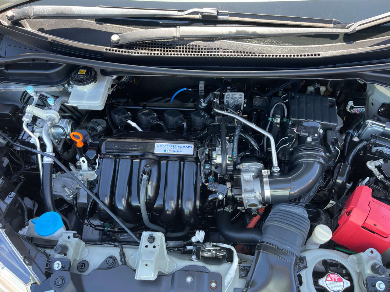 2018 Honda Fit 1.5 Hybrid engine compartment showcasing fuel-efficient components and design.