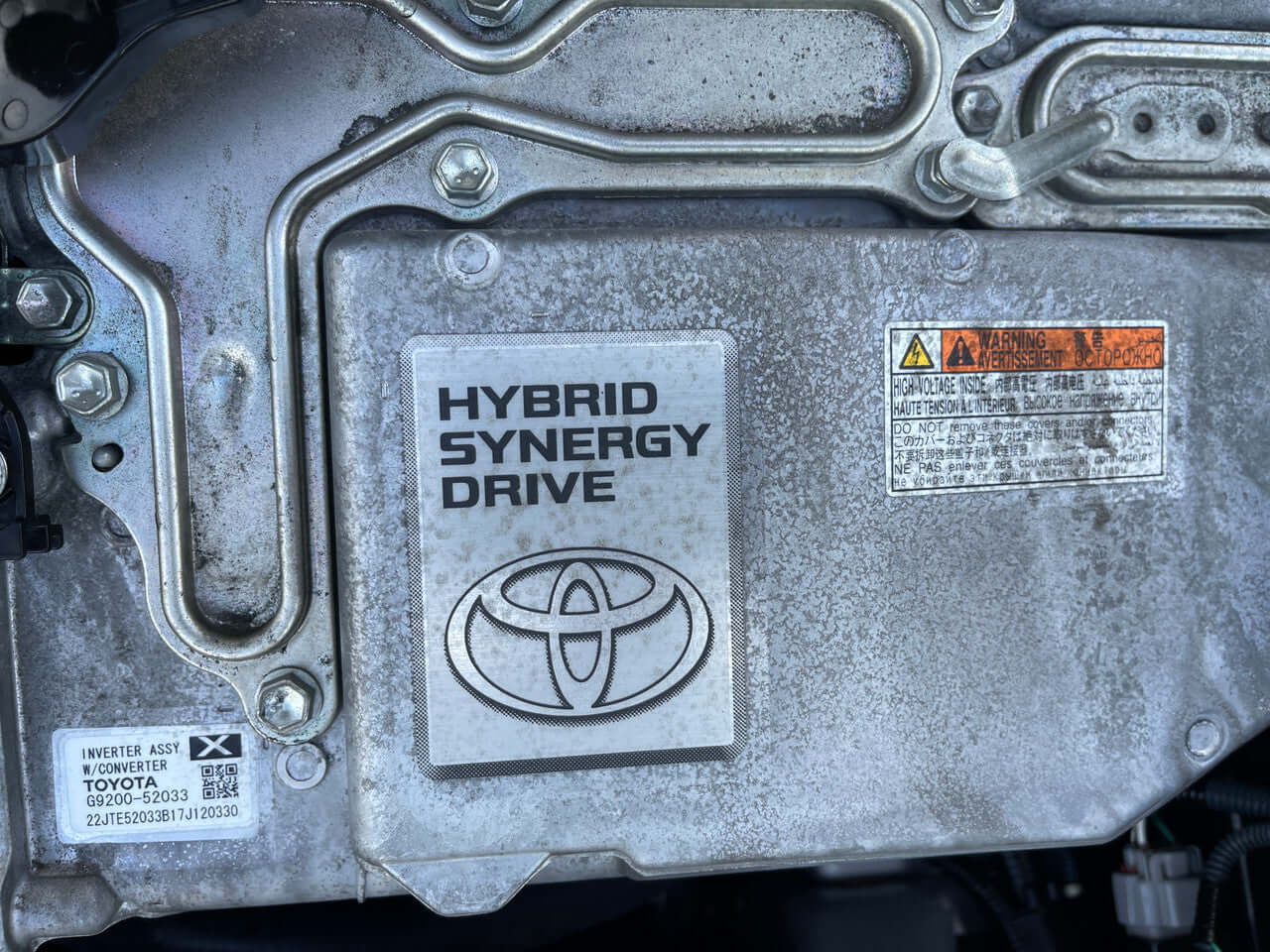 Toyota Hybrid Synergy Drive label, showcasing technology in a 2017 Toyota Vitz 1.5L Hybrid engine.
