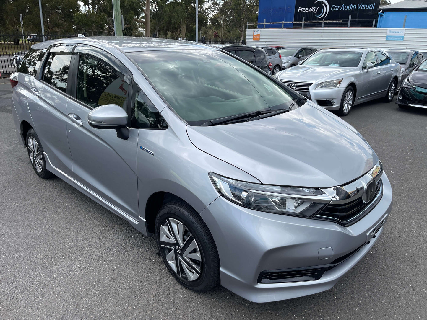 2019 Honda Shuttle 1.5L 4WD Hybrid X Honda Sensing Edition in silver color, parked with other cars in the background.