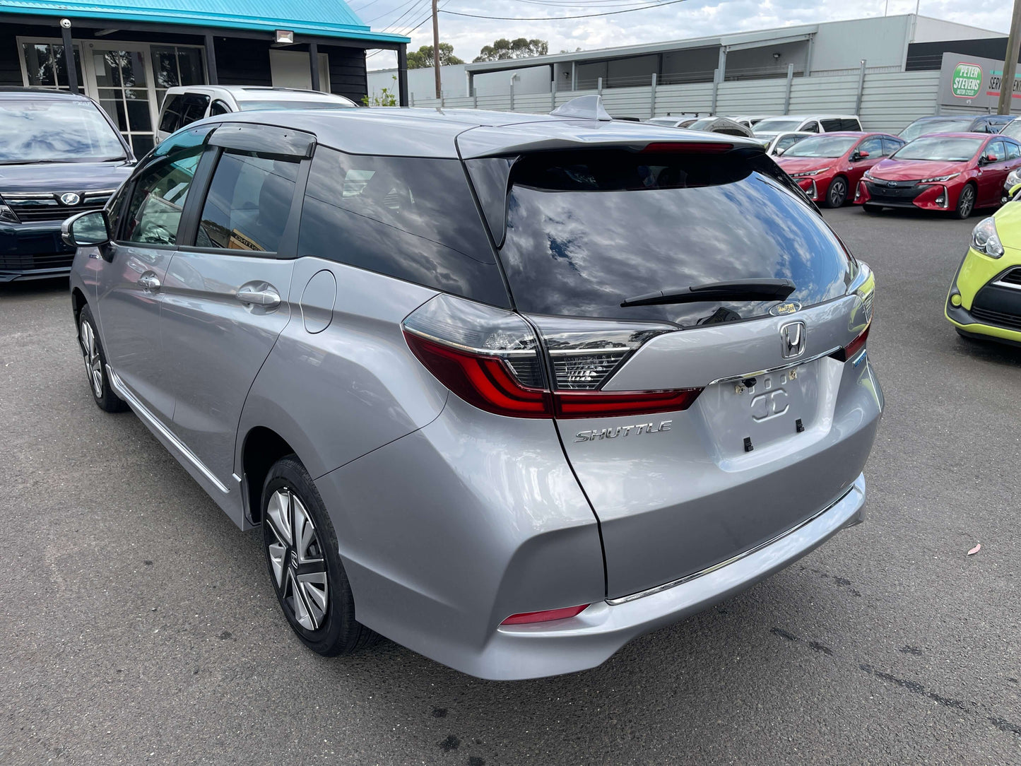 2019 Honda Shuttle 1.5L 4WD Hybrid X Honda Sensing Edition rear view showcasing a silver minivan.
