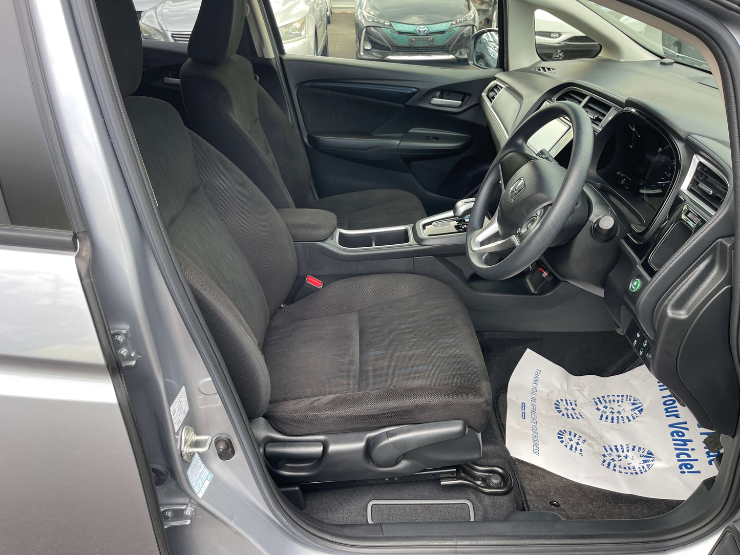 Interior view of 2019 Honda Shuttle 1.5L 4WD Hybrid showing spacious seating and dashboard features.