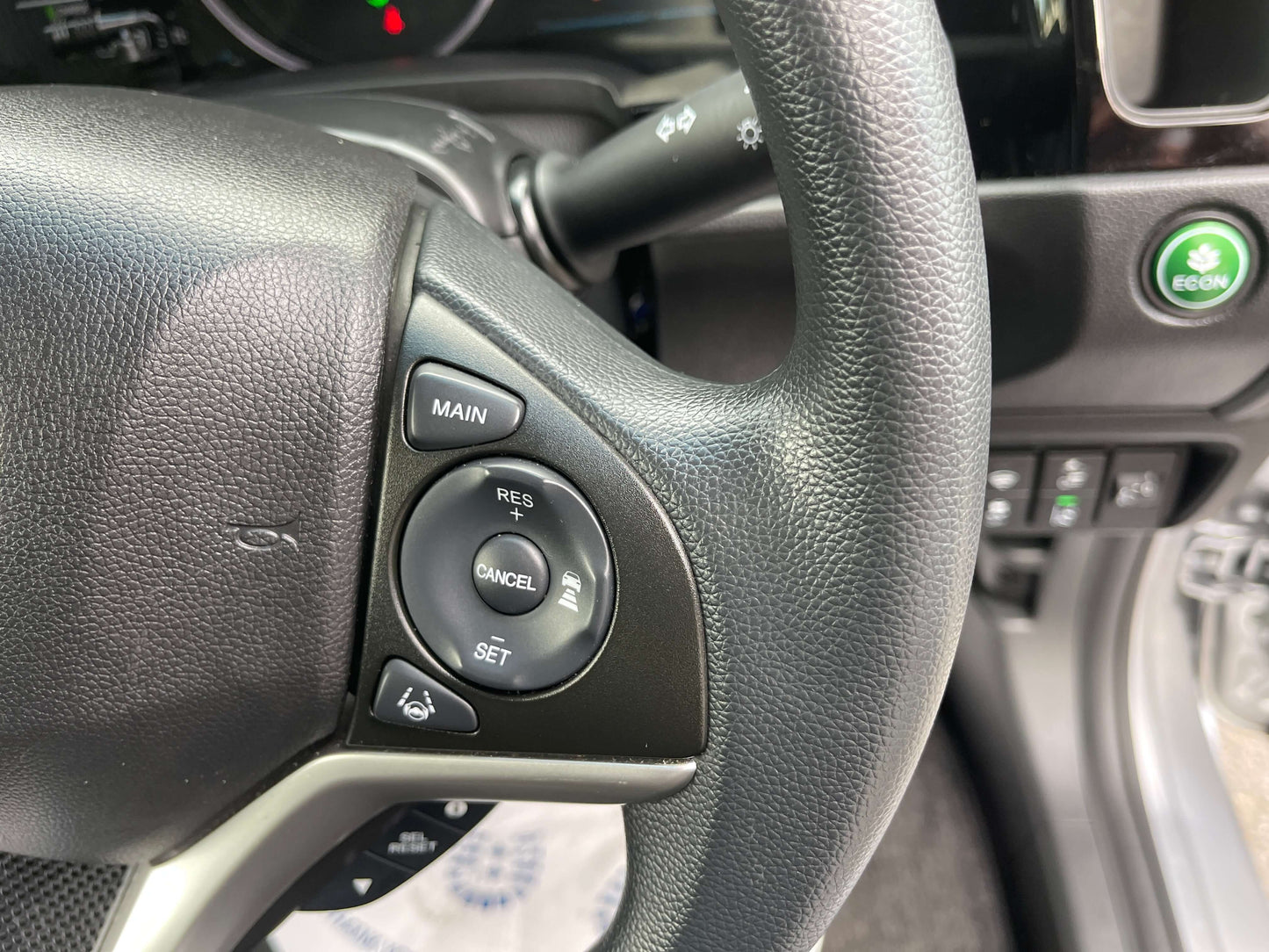 Close-up of the steering wheel controls including the Honda Sensing features in the 2019 Honda Shuttle 1.5L 4WD Hybrid.