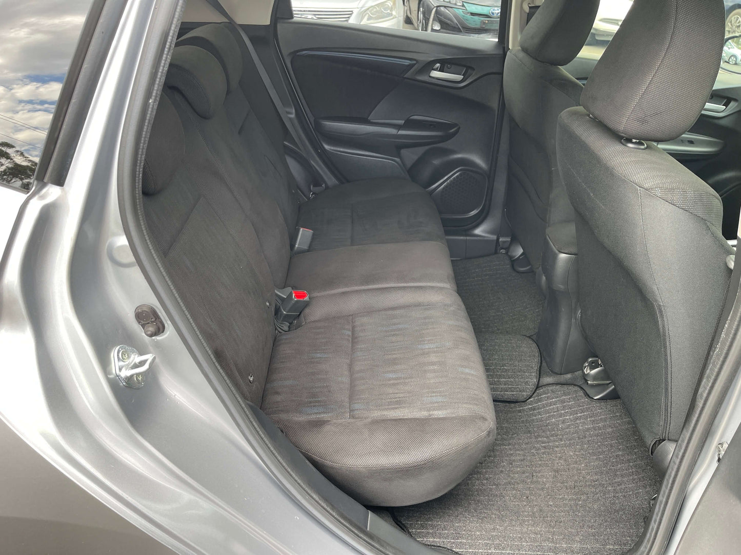 Interior view of the 2019 Honda Shuttle 1.5L 4WD Hybrid, showcasing spacious back seating area.