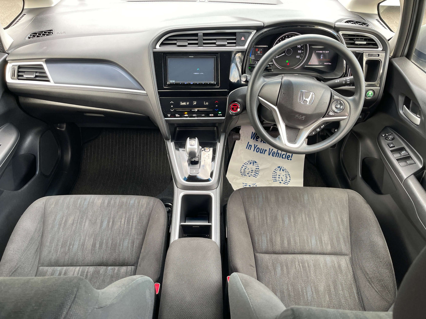 Interior view of 2019 Honda Shuttle 1.5L 4WD Hybrid showing dashboard and seating arrangement.